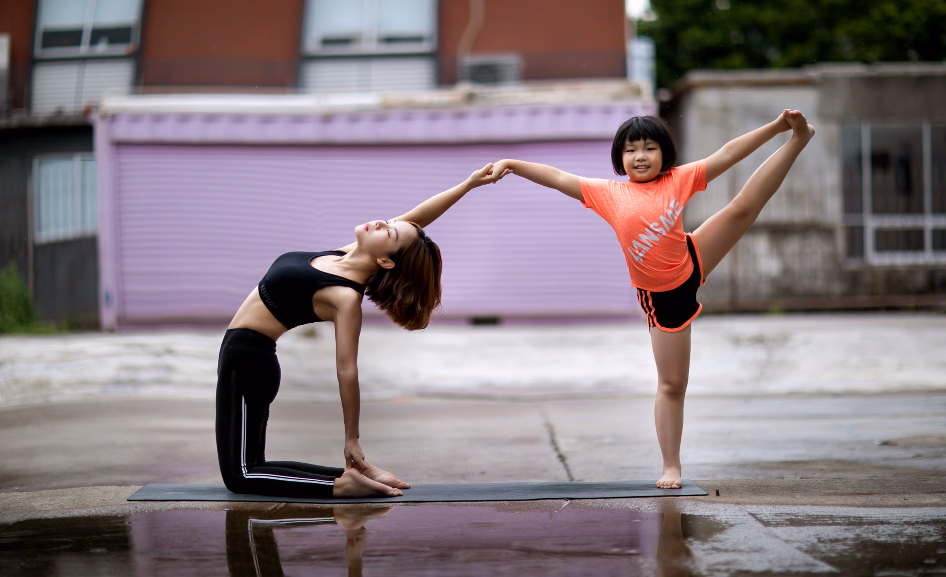 Parent and child dancing in the kitchen for exercise.