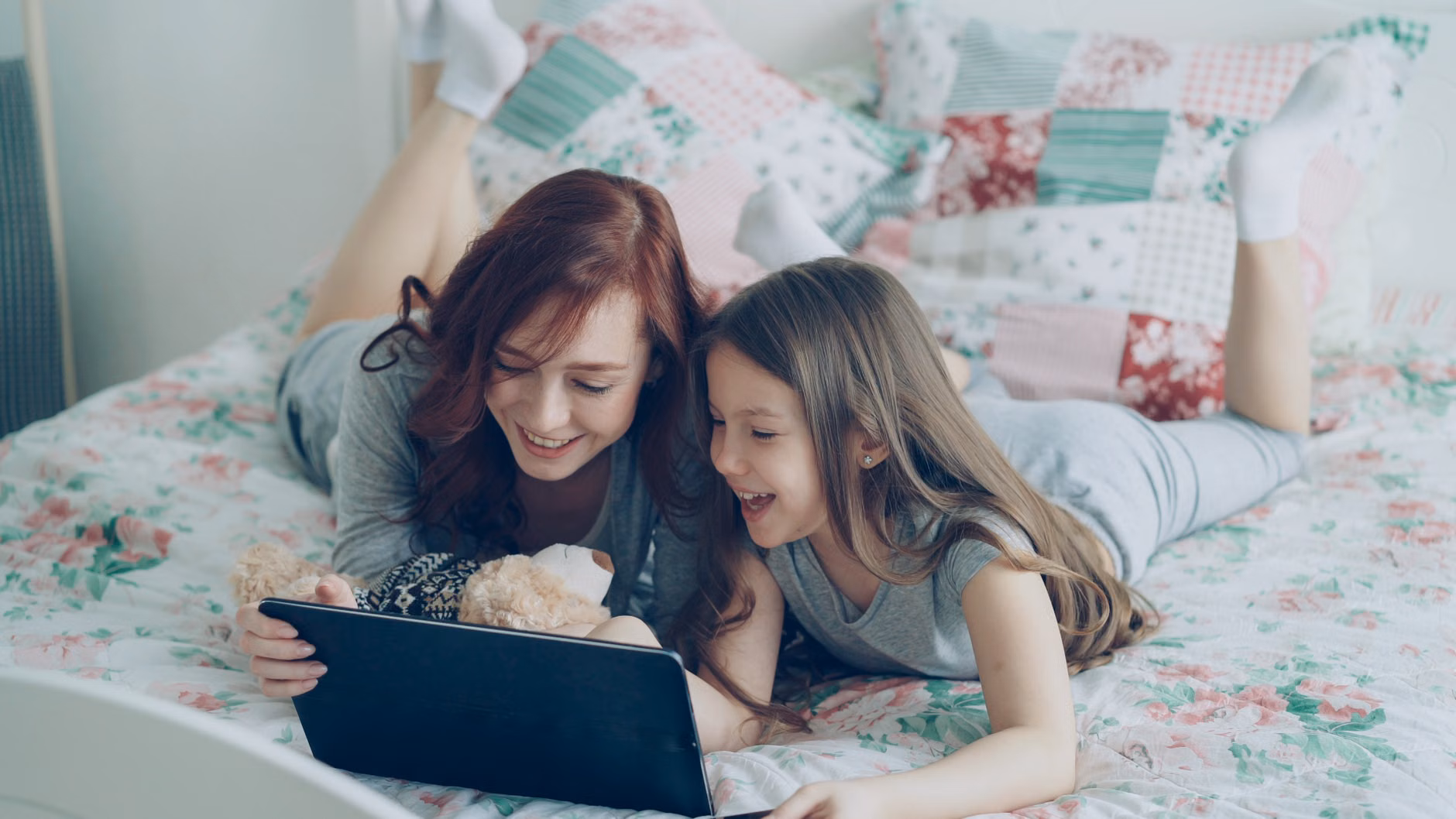 A parent and child browsing safely on a tablet.