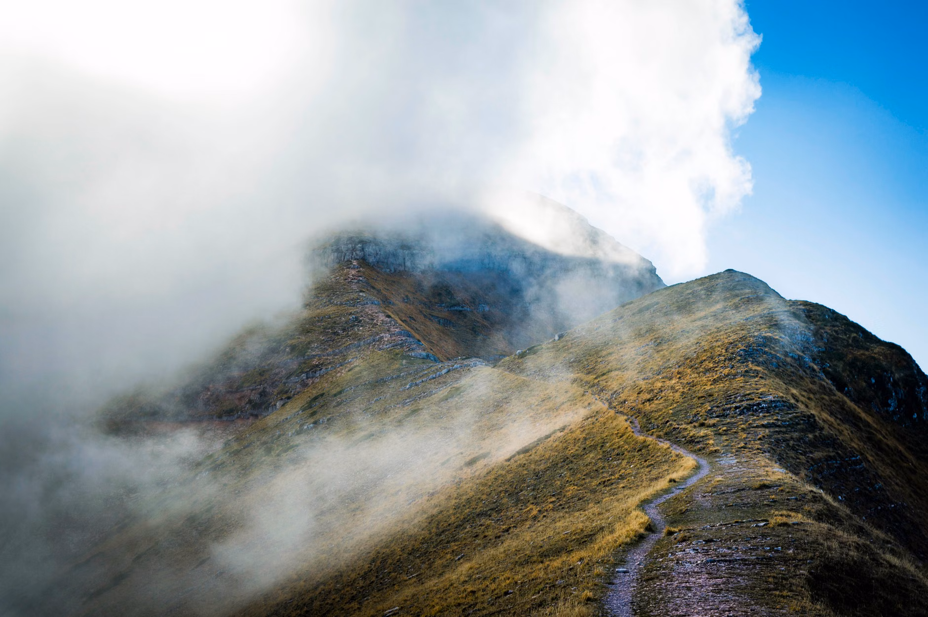 A tranquil, misty hiking trail in the mountains during the off-peak season.