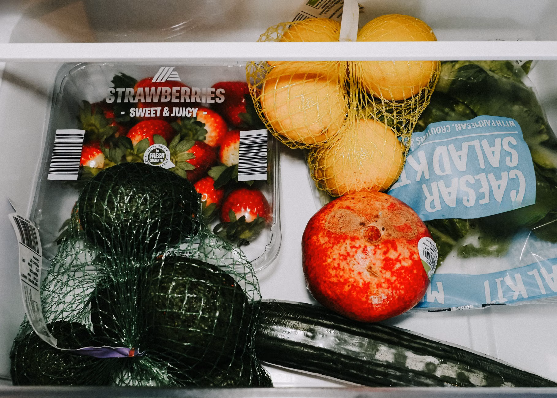 The interior of a well-organized refrigerator with clear food containers.