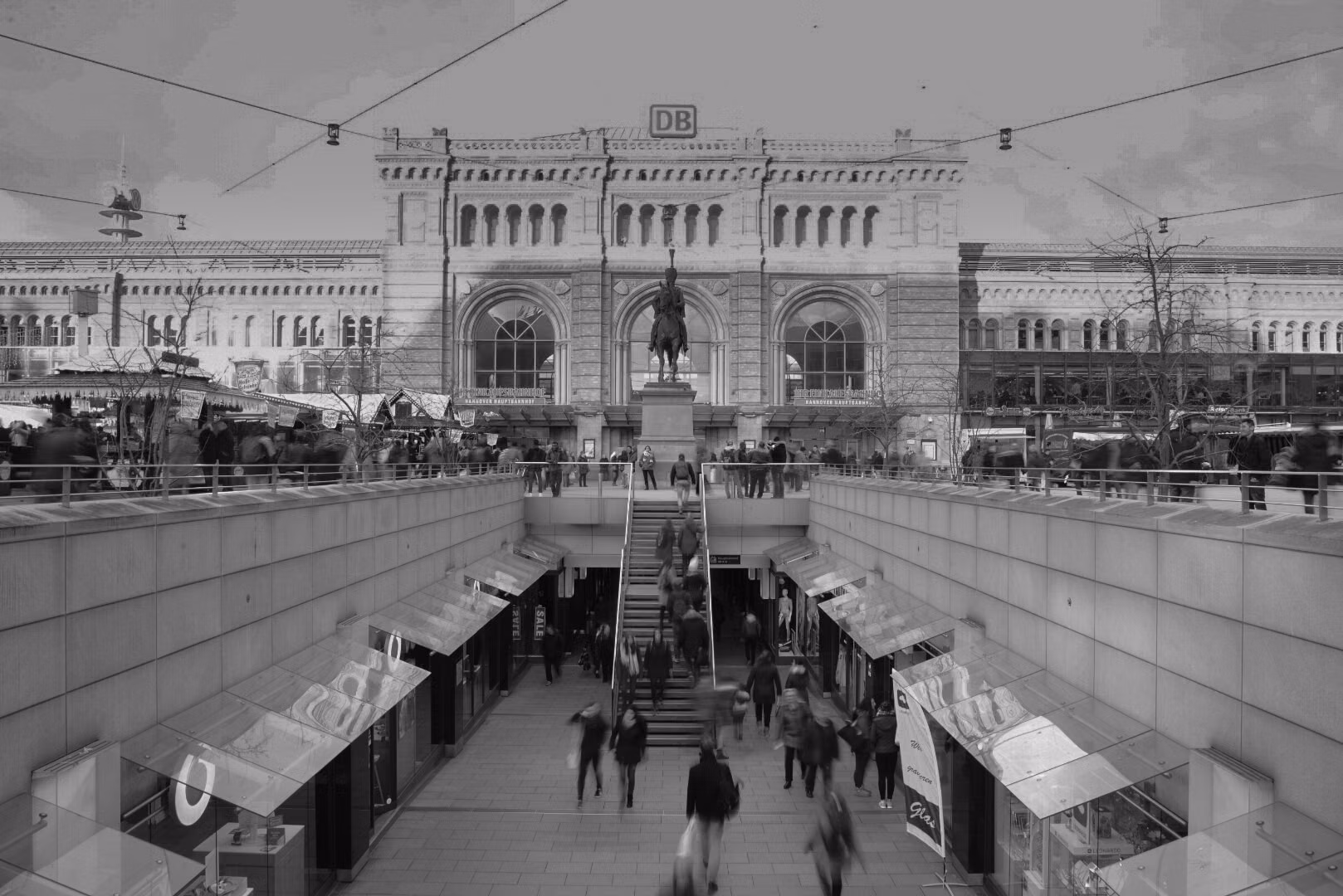 A bustling historic train station in Central Europe.