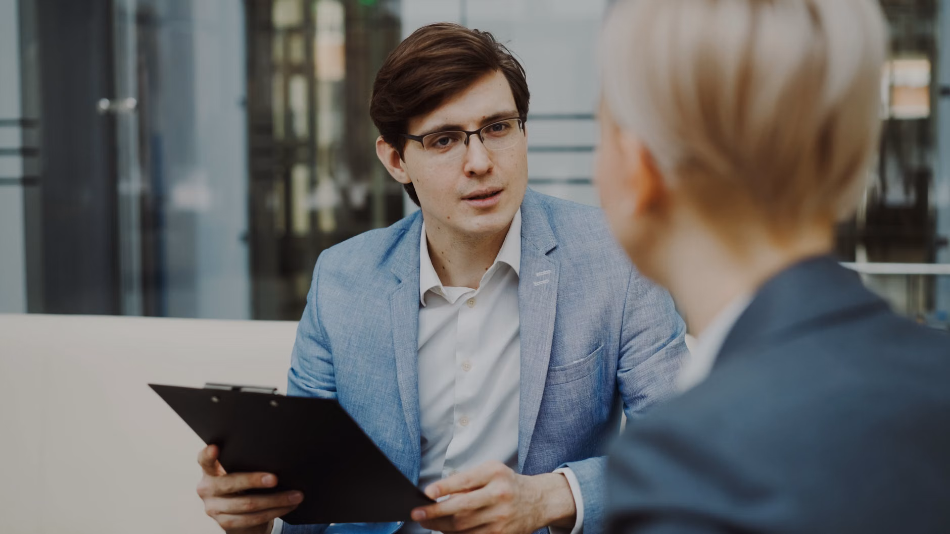 Two professionals discussing career and salary growth in a workspace.