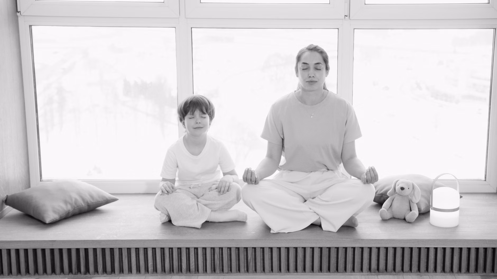 A parent and child engaging in co-regulation through deep breathing.