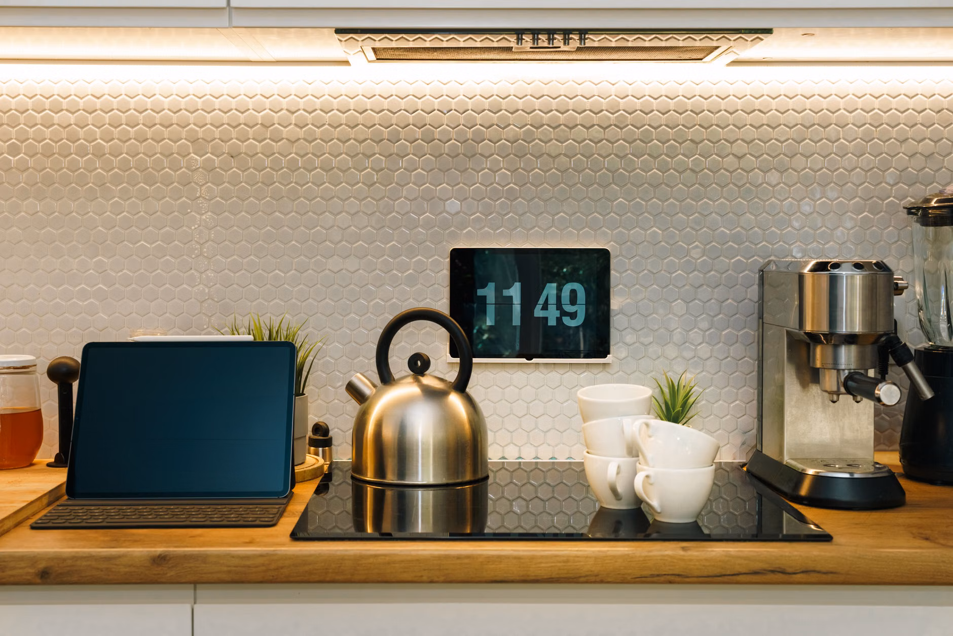 A tablet mounted on a wall acting as a central smart home controller.