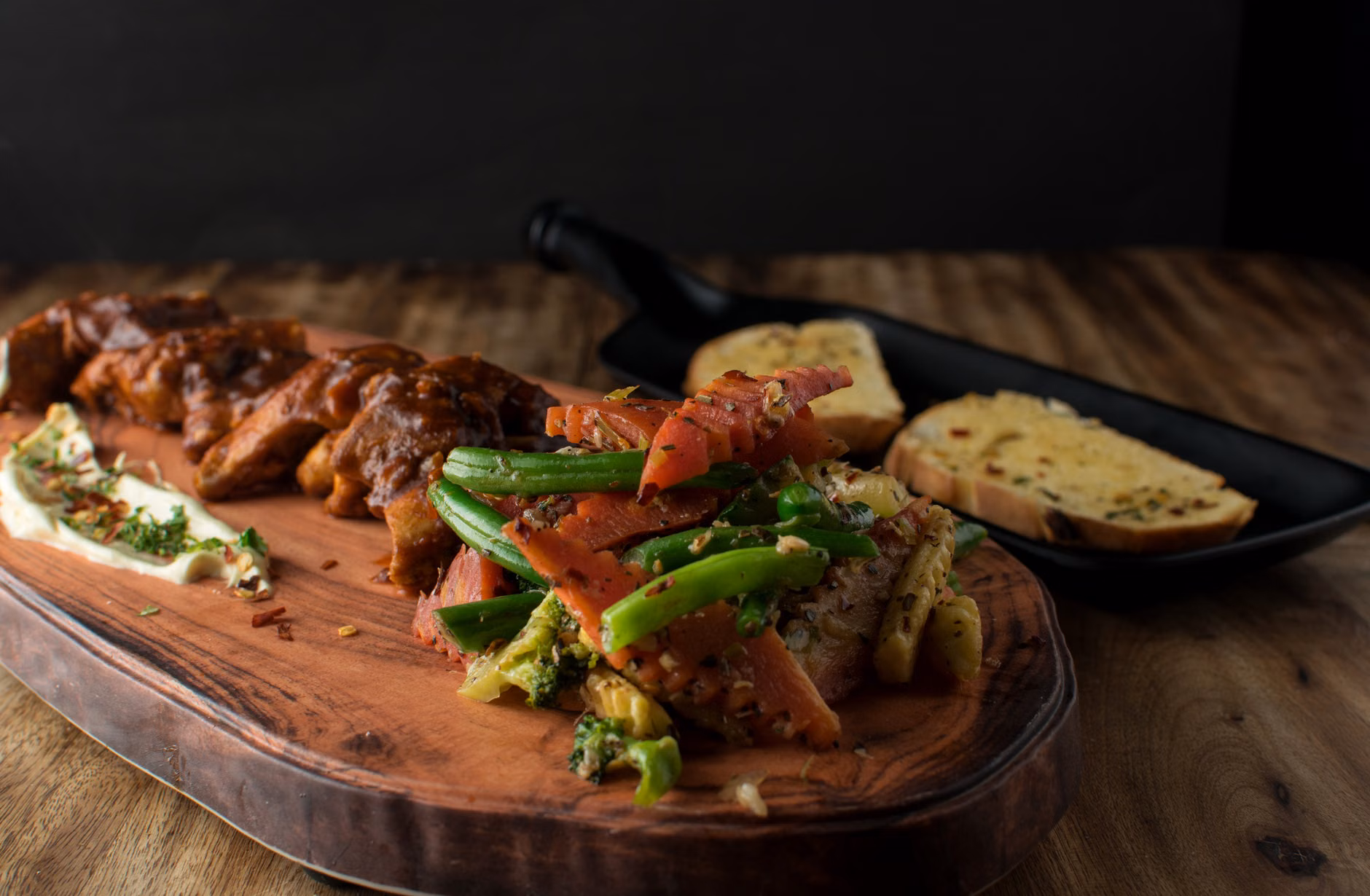 A home-cooked, healthy seasonal meal served on a wooden dinner table.