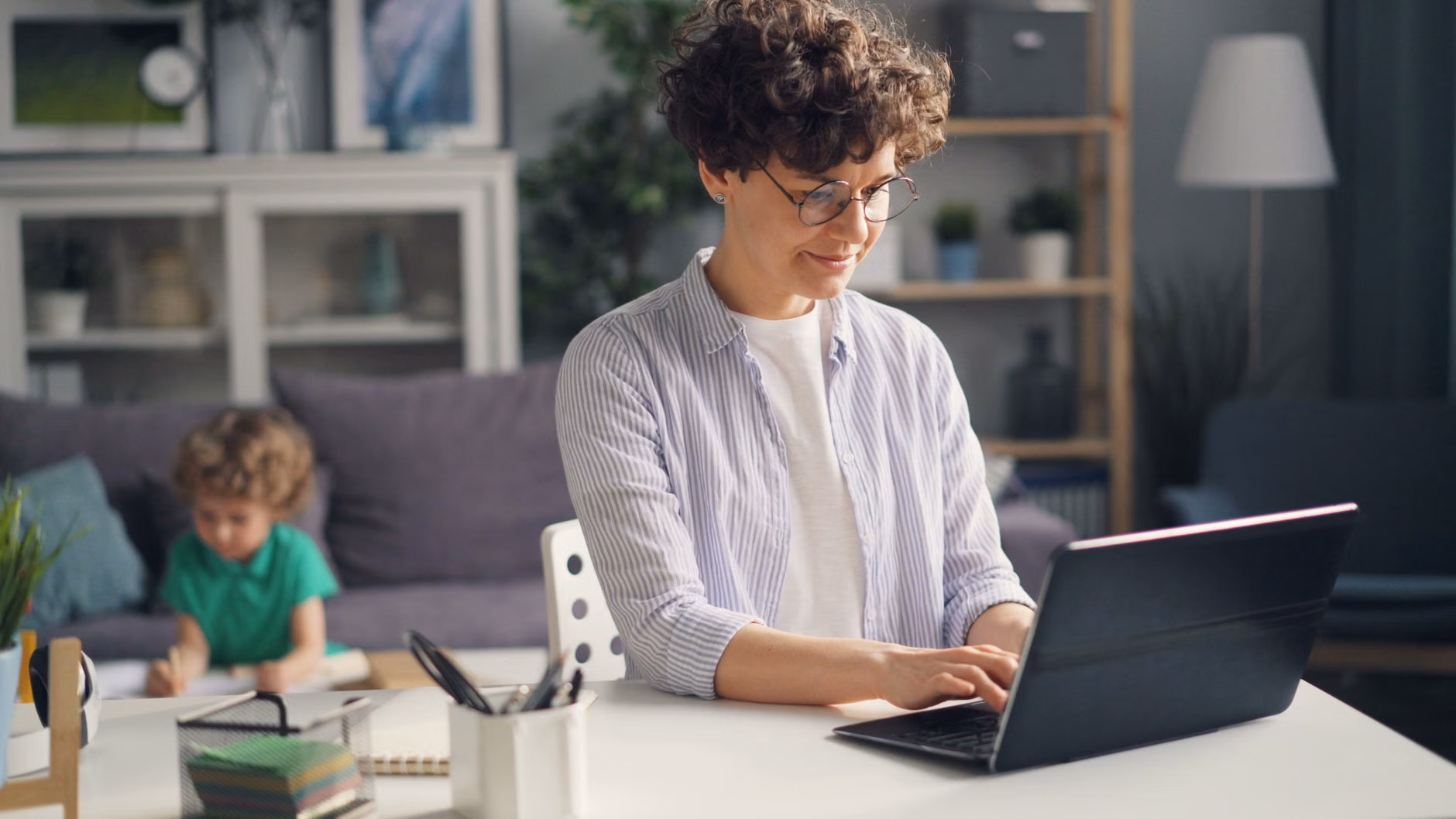 Parent working remotely in a home environment.