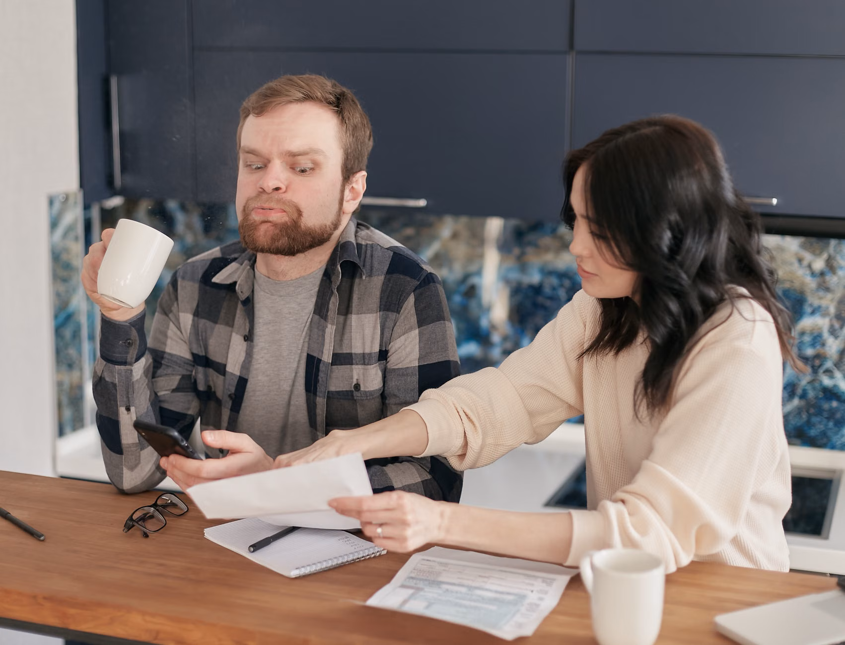 A family discussing household finances around a table.