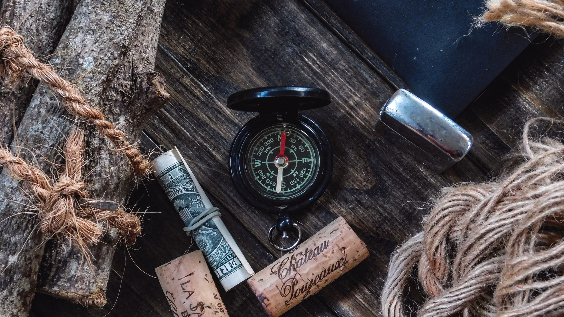 Outdoor exploration tools laid out on a forest floor.