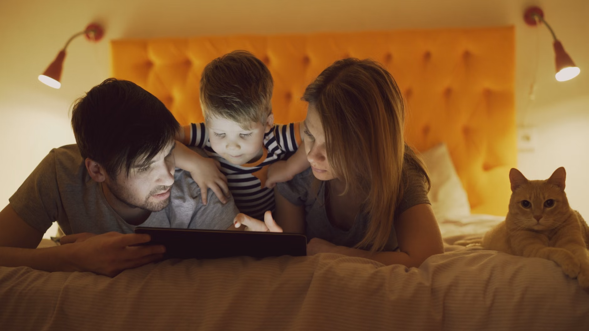 A parent and child reviewing energy data on a tablet