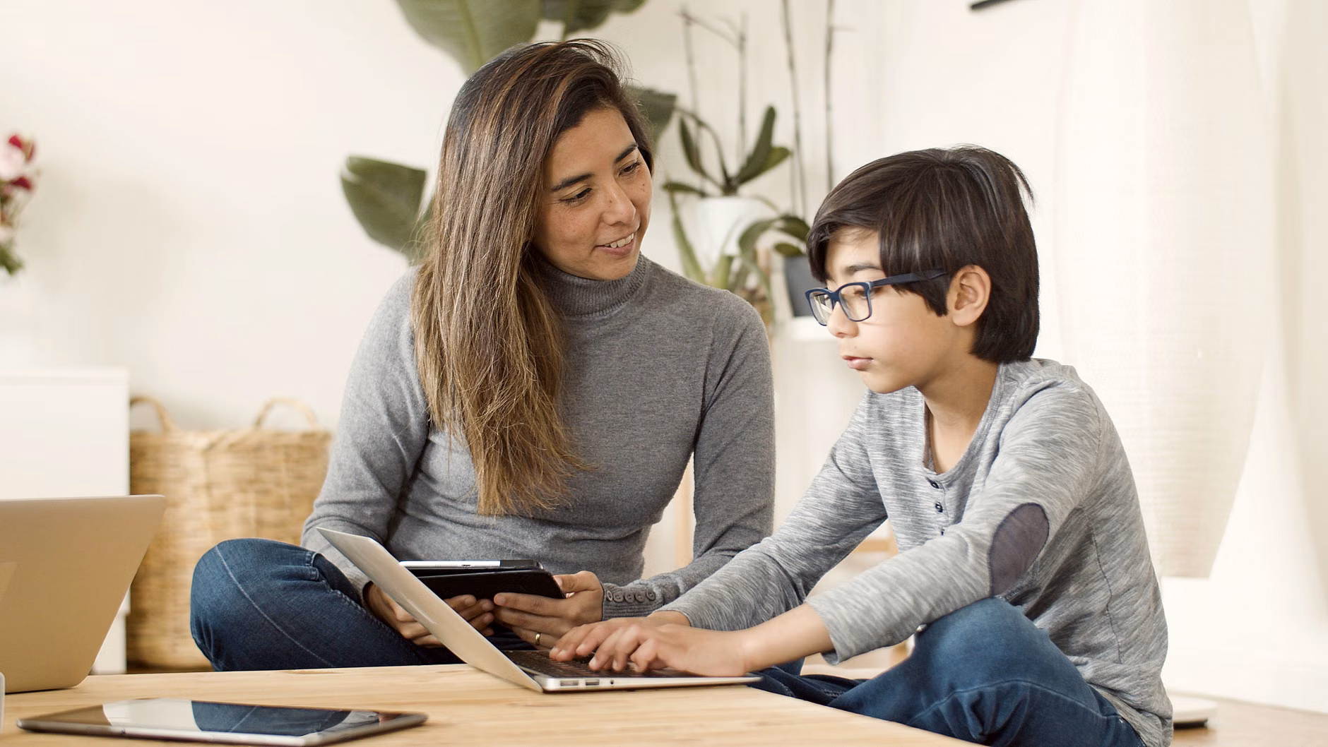Parent and child testing a used tablet together.