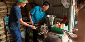 A family engaging with a local artisan in a workshop setting during their travels.