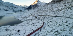 A scenic view of a European train passing through a beautiful landscape.