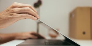 A person closing their laptop at the end of the day, symbolizing the right to disconnect.