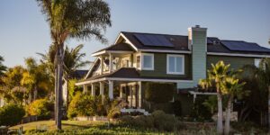 A modern energy-efficient home with solar panels in a sunny suburban neighborhood.