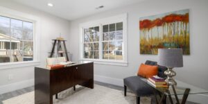 A clean, modern home office space with a window view, representing the remote work lifestyle.