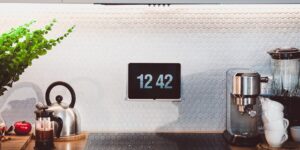 A modern smart kitchen setup with a mobile app for grocery tracking.