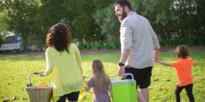 A family enjoying a simple, low-stress picnic in a local park as a micro-adventure.