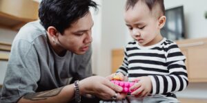 Parent and child engaged in emotional intelligence play in a modern home setting.