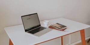 A clean desk setup with a laptop and coffee, symbolizing organized digital life.
