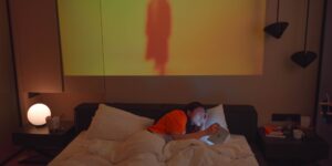 A modern bedroom with warm smart lighting designed for better sleep.