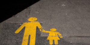 A parent calmly guiding a child in a public space.