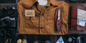 A travel-themed aesthetic shot of hiking boots and a notebook, representing the single-topic vacation.