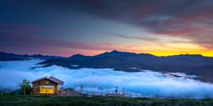 A peaceful mountain cabin at dawn representing a solo retreat.