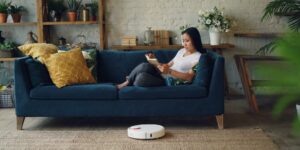 A modern living room with lush indoor plants and smart gardening technology.