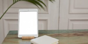 A clean, modern workspace featuring a tablet and a wooden box, symbolizing the blend of digital and physical legacy.