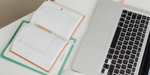 A minimalist desk setup featuring a paper planner and a smartphone turned face down to signify a focus on analog tools.