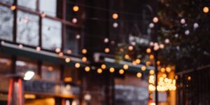 A warm, inviting neighborhood micro-festival scene at sunset.