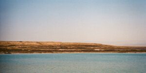 A peaceful, deserted coastline under a clear sky.