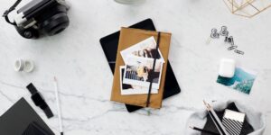 A workspace with physical items representing the shift from digital subscriptions to tangible ownership.