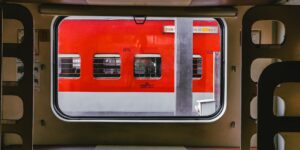 A modern European sleeper train compartment at night with a view of the landscape.
