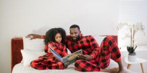 A parent and child reading together in a cozy, modern living room.