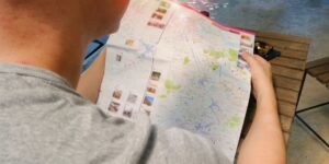 A person using a digital map to navigate a historic city district.