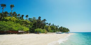 A peaceful, empty coastline representing the ideal quiet beach destination for families.