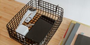 A clean, organized desk with various family devices charging in a minimalist home setting.