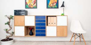 A clean, minimalist living room with organized toy storage.