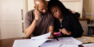 A family reviewing their household budget on a tablet