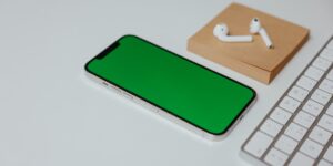 A clean desk setup with a smartphone displaying a digital photo gallery.