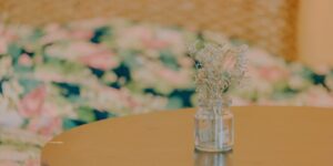 A glass jar for emotional vocabulary on a wooden table.