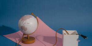 Modern desk with a globe and tablet representing global tax planning for families.