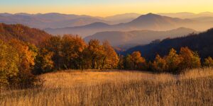 A peaceful mountain landscape during the shoulder season with golden hour light.