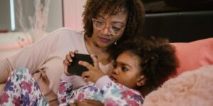 A parent and child sharing a calm, quiet moment in a cozy, dimly lit living room.