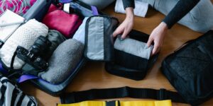 A curated collection of sensory-friendly travel gear laid out neatly on a wooden surface.