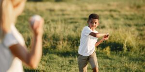 A child playing sports in a field with a focus on effort rather than competition.