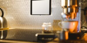 A minimalist smart home dashboard on a wall tablet in a modern living room