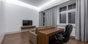 A clean, modern shared home office space with distinct zones for productivity.