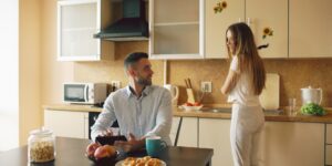 A couple having a calm conversation at a kitchen table